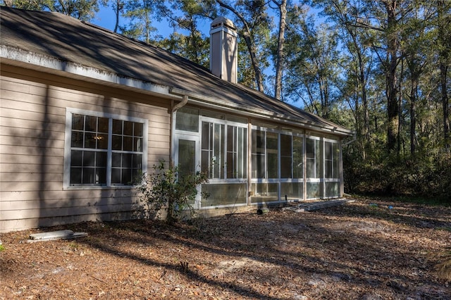 view of side of home with a sunroom