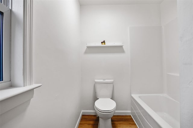 bathroom featuring hardwood / wood-style flooring and toilet