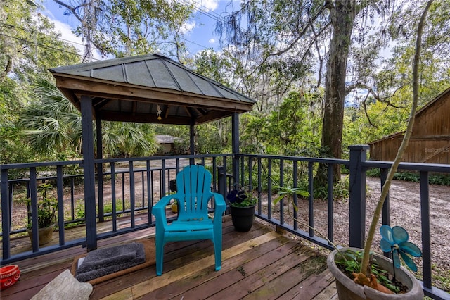 wooden terrace featuring a gazebo