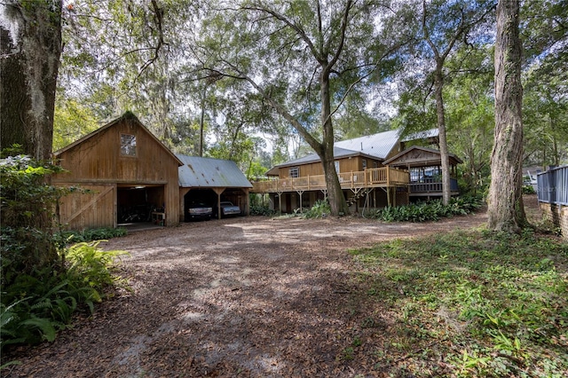 view of yard featuring an outdoor structure and a wooden deck