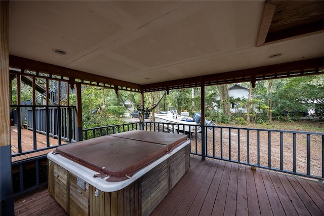 wooden deck featuring a hot tub