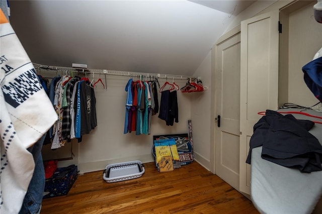 spacious closet with wood-type flooring and vaulted ceiling