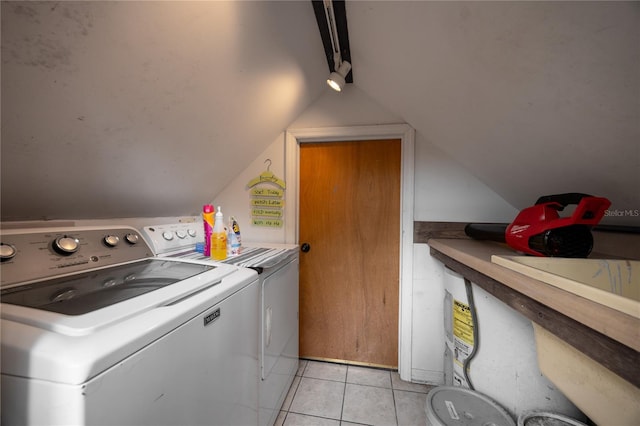 laundry room with washing machine and clothes dryer and light tile patterned floors