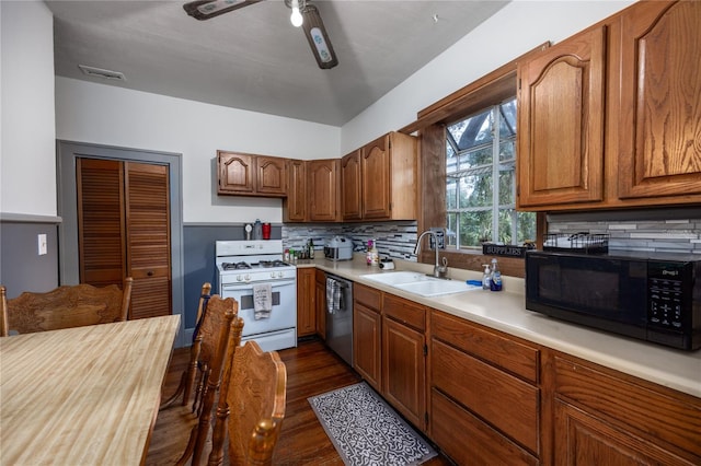 kitchen with dishwasher, sink, tasteful backsplash, dark hardwood / wood-style flooring, and gas range gas stove