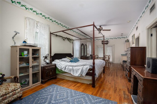 bedroom with ceiling fan and wood-type flooring