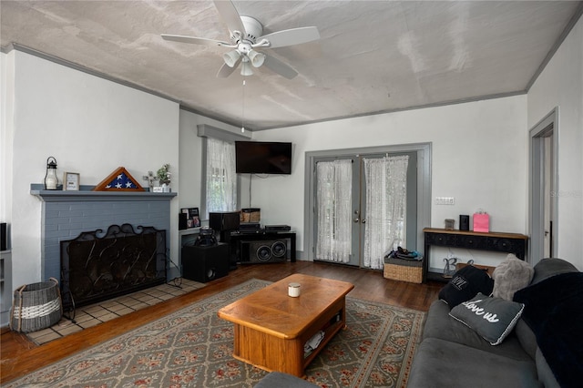 living room featuring a fireplace, french doors, dark hardwood / wood-style floors, and ceiling fan