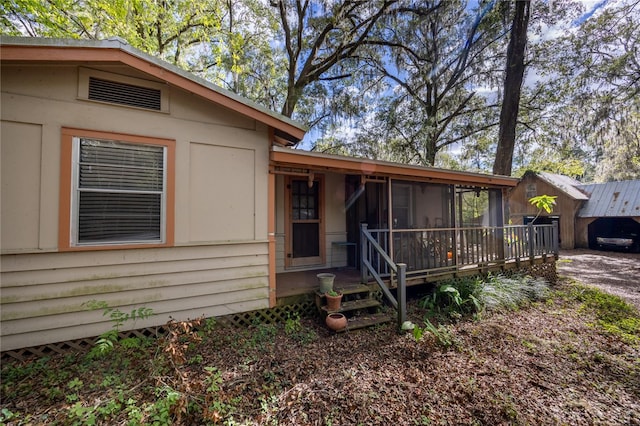 view of front of home with a sunroom