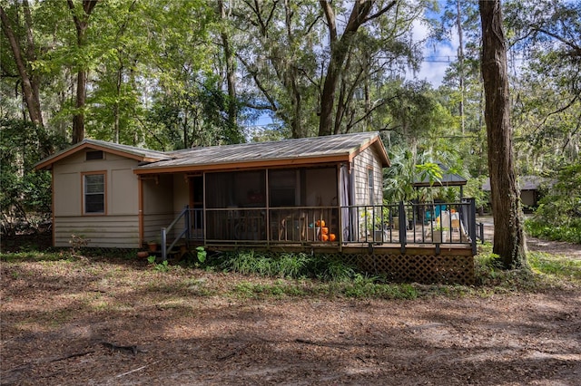 rear view of house featuring a wooden deck