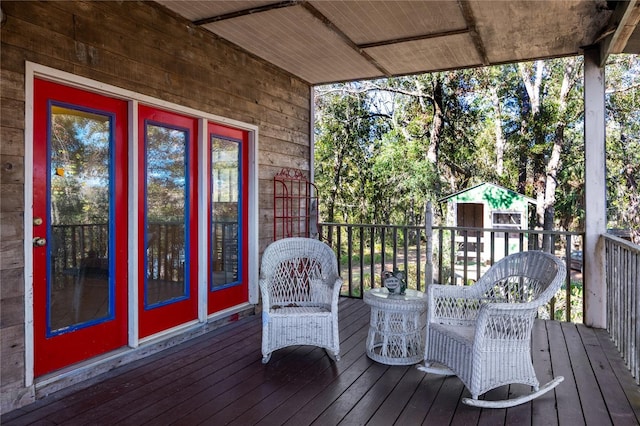 wooden deck with an outbuilding