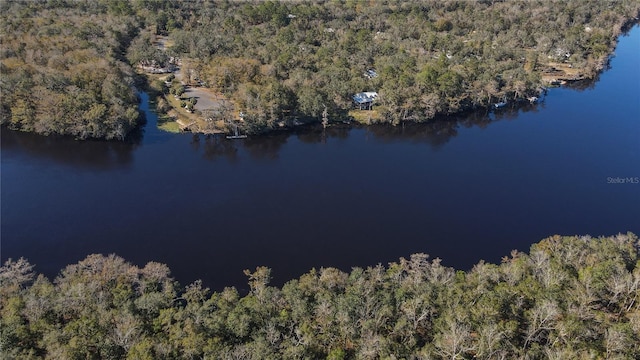 birds eye view of property featuring a wooded view and a water view