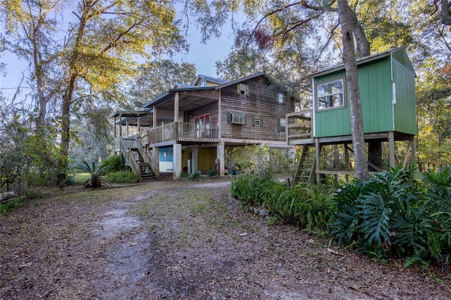 back of property with stairway and a wooden deck