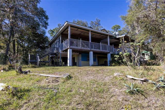 rear view of property with a wooden deck