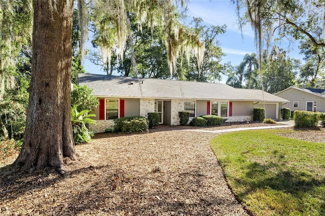 ranch-style home featuring a front yard