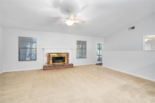 unfurnished living room with ceiling fan, light colored carpet, a fireplace, and vaulted ceiling