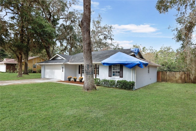 ranch-style home featuring a garage and a front yard