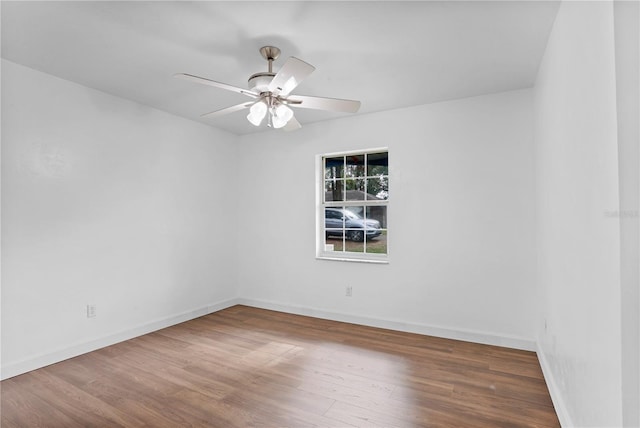 empty room with hardwood / wood-style floors and ceiling fan