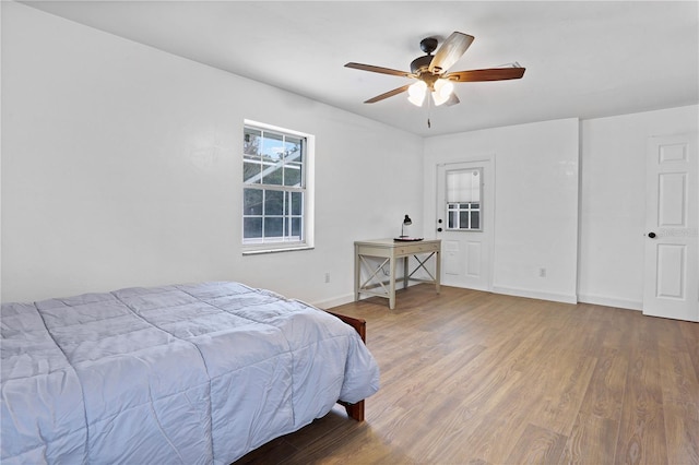 bedroom with hardwood / wood-style flooring and ceiling fan