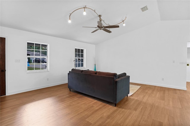 living room with ceiling fan, light hardwood / wood-style floors, and lofted ceiling