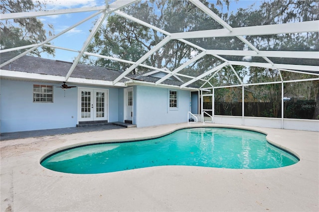 view of swimming pool featuring a lanai, ceiling fan, french doors, and a patio