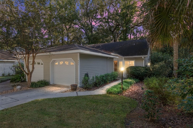 view of front of home with a yard and a garage