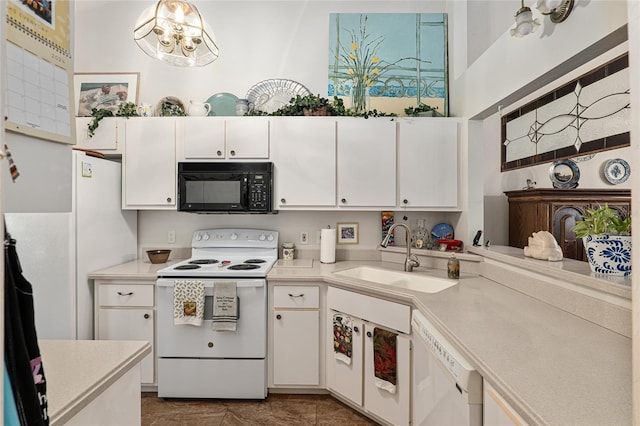 kitchen with white appliances, sink, pendant lighting, a notable chandelier, and white cabinetry