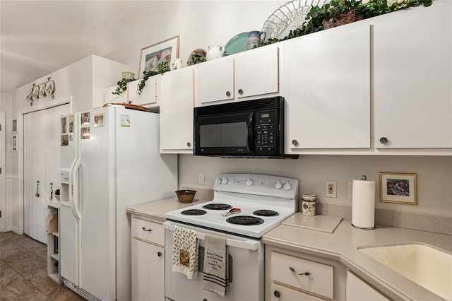 kitchen featuring white cabinets, white appliances, and tile patterned floors