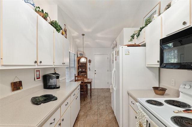 kitchen featuring white electric stove, white cabinetry, and hanging light fixtures