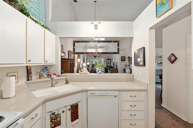 kitchen featuring white cabinetry, sink, decorative light fixtures, and white appliances