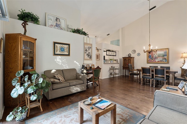 living room featuring a notable chandelier, dark hardwood / wood-style floors, and high vaulted ceiling