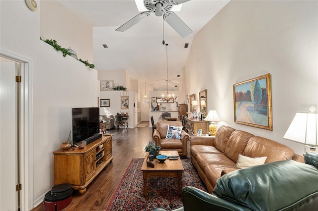 living room featuring ceiling fan with notable chandelier, high vaulted ceiling, and dark hardwood / wood-style floors