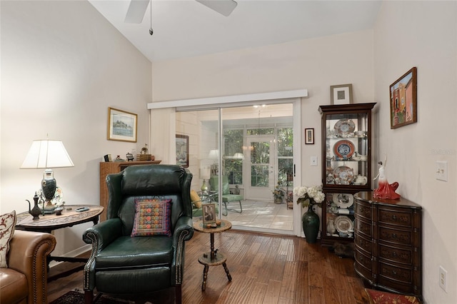 living area featuring wood-type flooring, vaulted ceiling, and ceiling fan