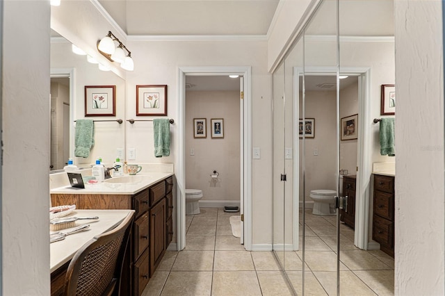 bathroom featuring tile patterned flooring, vanity, ornamental molding, and toilet