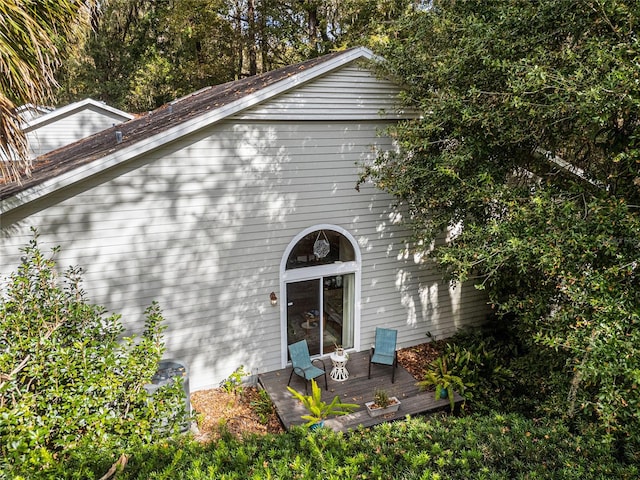 view of side of home with a wooden deck