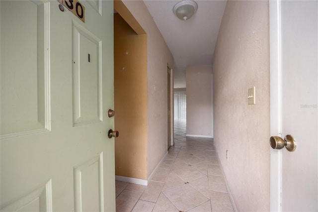 hall with light tile patterned floors