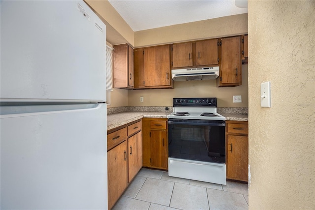 kitchen with light tile patterned flooring and white appliances