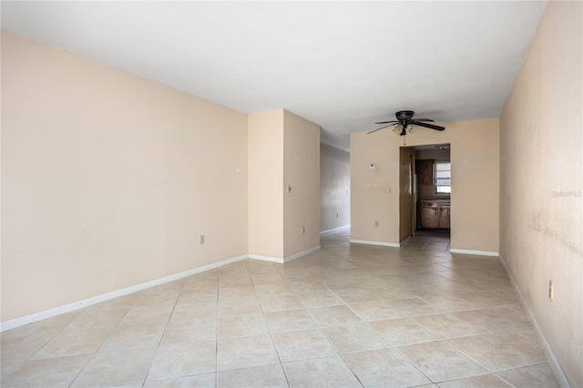 tiled spare room featuring ceiling fan