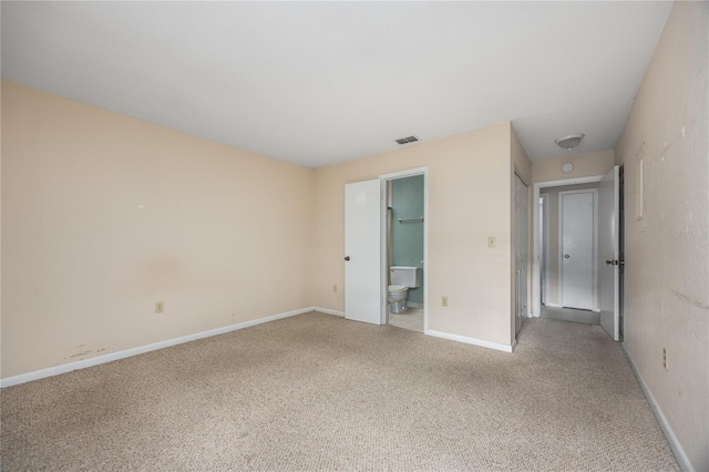 unfurnished bedroom with carpet flooring, ensuite bath, and a closet