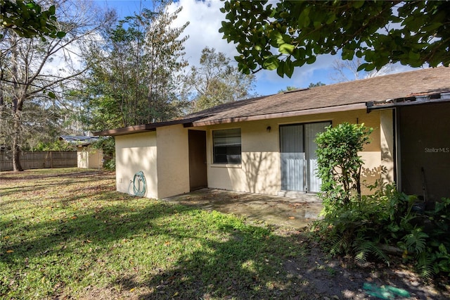 back of house with a lawn