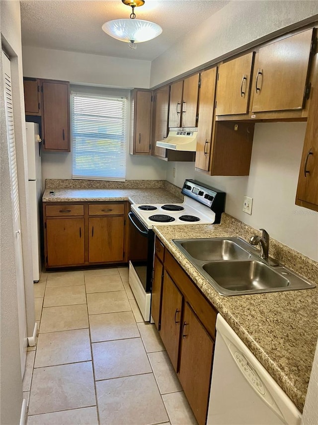3430 NW 21st Dr Unit D-2, Gainesville, FL 32605 - kitchen with white appliances, a sink, under cabinet range hood, light tile patterned floors, and light countertops