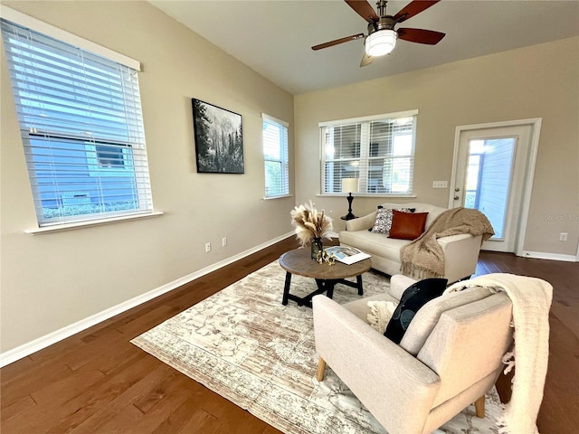 living room featuring dark hardwood / wood-style floors, a wealth of natural light, and ceiling fan