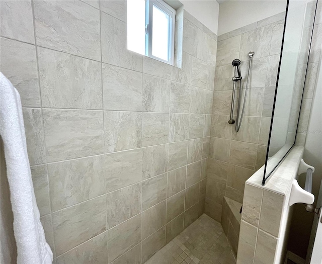 bathroom with tiled shower