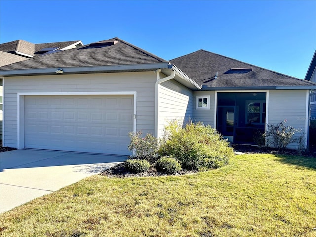 ranch-style home with a garage and a front lawn