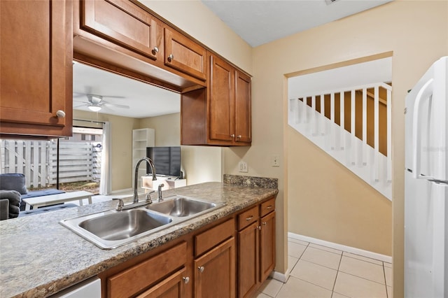 kitchen with ceiling fan, sink, dishwasher, white fridge, and light tile patterned flooring