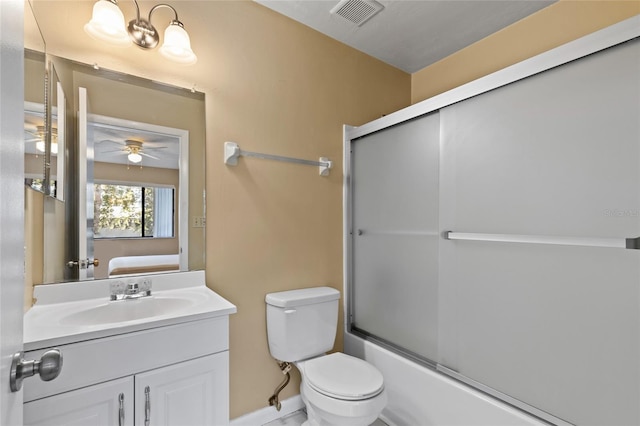 full bathroom featuring shower / bath combination with glass door, ceiling fan, vanity, and toilet