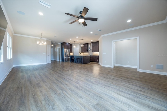 unfurnished living room with crown molding, dark hardwood / wood-style flooring, ceiling fan with notable chandelier, and sink