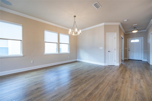 unfurnished room featuring dark hardwood / wood-style floors, a healthy amount of sunlight, crown molding, and an inviting chandelier