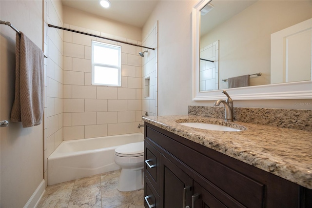 full bathroom featuring vanity, toilet, and tiled shower / bath