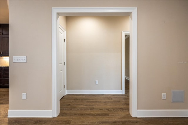 corridor featuring dark hardwood / wood-style floors