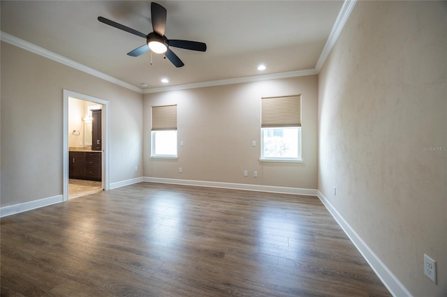 unfurnished room featuring ornamental molding, dark wood-type flooring, and a wealth of natural light