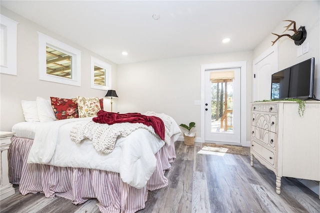 bedroom with access to exterior and wood-type flooring